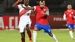 Advincula of Peru (left) fights for ball control against Vidal of Chile