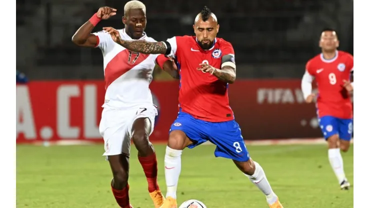 Advincula of Peru (left) fights for ball control against Vidal of Chile