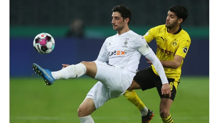 Lars Stindi of Monchengladbach (left) fight for ball control with Mahmoud Dahoud of Dortmund (right)