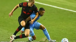 Tom Barlow of New York Red Bulls (left) fights for ball control against Alexander Callens of New York City FC (right)