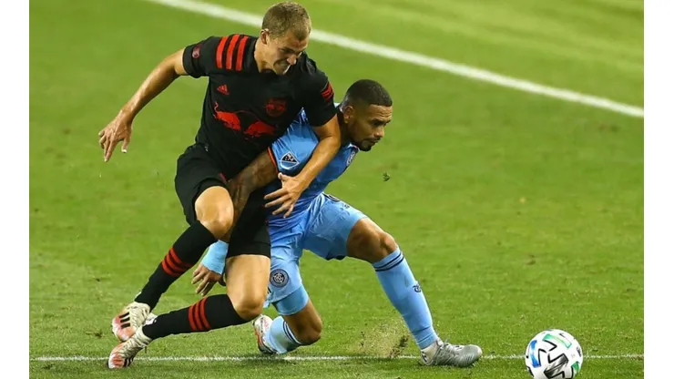 Tom Barlow of New York Red Bulls (left) fights for ball control against Alexander Callens of New York City FC (right)