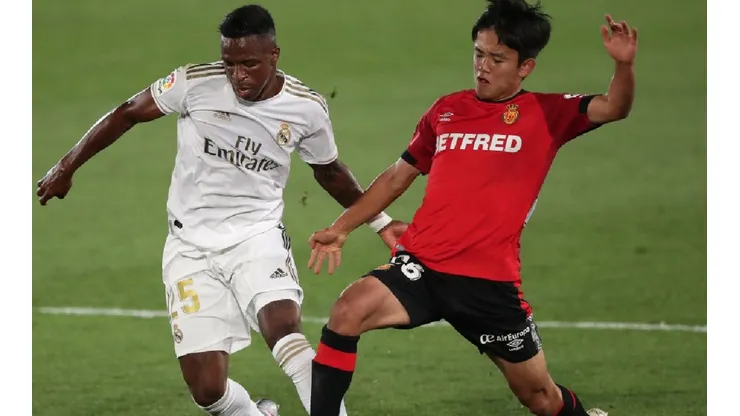 Vinicius of Real Madrid (left) fights for ball control with Kubo of Mallorca (right)
