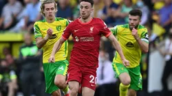 Dioga Jota runs away from two Norwich City players in a Premier League game.