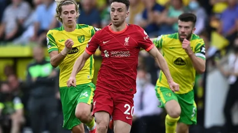 Dioga Jota runs away from two Norwich City players in a Premier League game.