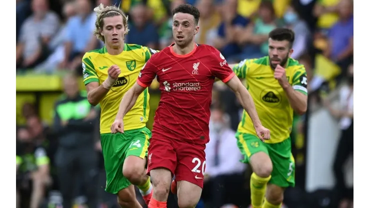Dioga Jota runs away from two Norwich City players in a Premier League game.
