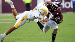 Ainias Smith of the Texas A&M Aggies (right) is tackled by Dean Clark of the Kent State Golden Flashes (left). (Getty)