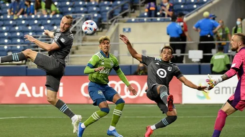 Brent Kallman #14 of Minnesota United FC heads a shot towards the goal as Stefan Frei #24 of Seattle Sounders FC defends during the second half of the match at Lumen Field on April 16, 2021 in Seattle, Washington. Seattle won 4-0. (Getty)