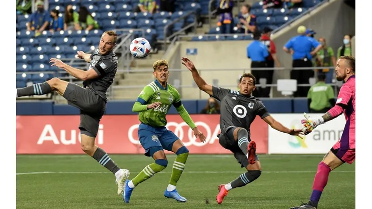 Brent Kallman #14 of Minnesota United FC heads a shot towards the goal as Stefan Frei #24 of Seattle Sounders FC defends during the second half of the match at Lumen Field on April 16, 2021 in Seattle, Washington. Seattle won 4-0. (Getty)