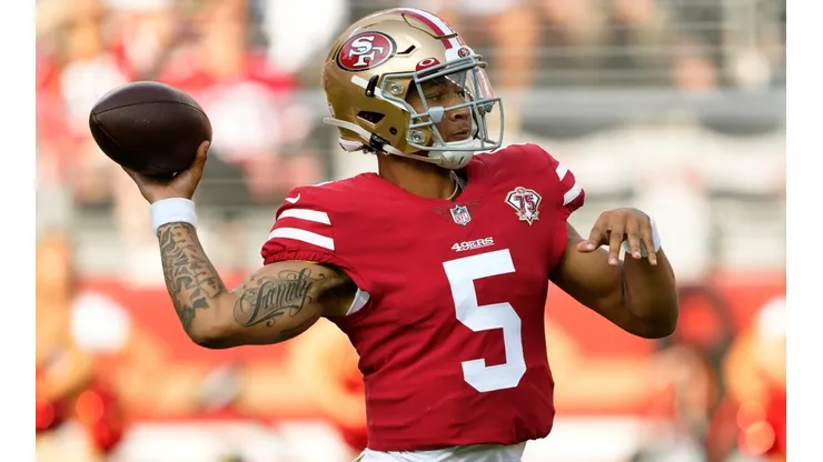 Trey Lance of the San Francisco 49ers throws a touchdown pass. (Getty)