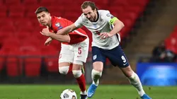 Jan Bednarek of Poland (left) fights for ball control against Harry Kane of England (right) (Getty)