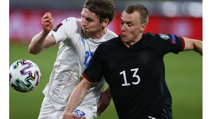 Jon Dadi Bodvarsson of Iceland (left) fights for ball control against Lukas Klostermann of Germany (right) (Getty)