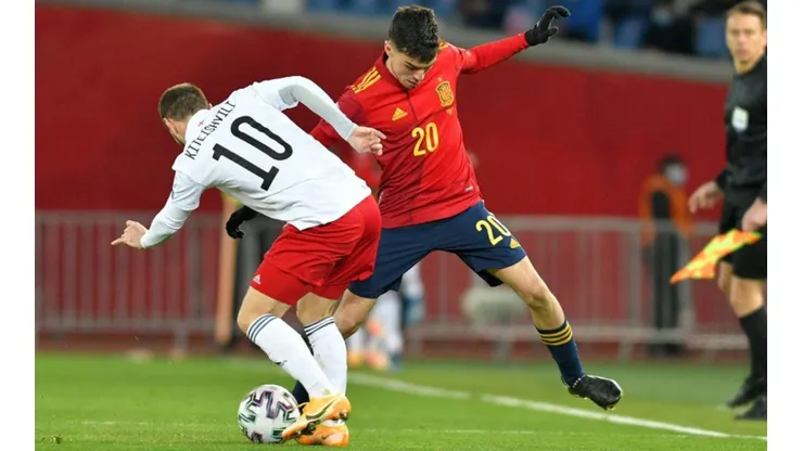 Otar Kiteishvili of Georgia (left) fights for ball control with Pedri of Spain (right) (Getty)