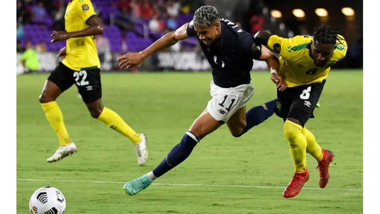 Ariel Lassiter of Costa Rica (middle) tries to win ball control against Oniel Fisher of Jamaica (left) (Getty)