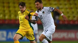 Markas Beneta of Lithuania (left) fights for ball control against Ciro Immobile of Italy (right) (Getty)