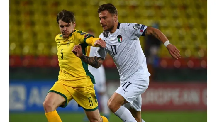 Markas Beneta of Lithuania (left) fights for ball control against Ciro Immobile of Italy (right) (Getty)