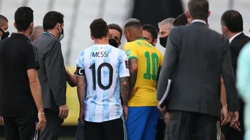 Messi and Neymar talk with Brazil's health authorities on the pitch (Getty).