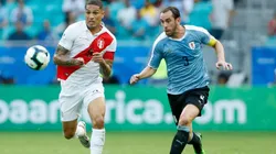Paolo Guerrero of Peru (left) runs for ball control against Diego Godin of Uruguay (right) (Getty)