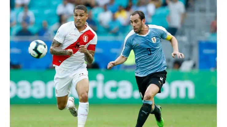 Paolo Guerrero of Peru (left) runs for ball control against Diego Godin of Uruguay (right) (Getty)