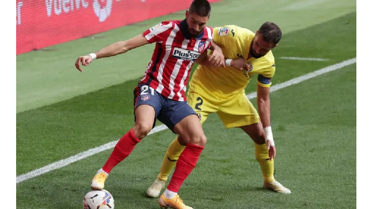 Yannick Carrasco of Atletico Madrid (left) holds the ball while Mario Gaspar of Villarreal (right) tries to block him (Getty)