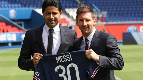 ionel Messi poses with his jersey next to PSG's President Nasser Al Khelaifi (Getty).