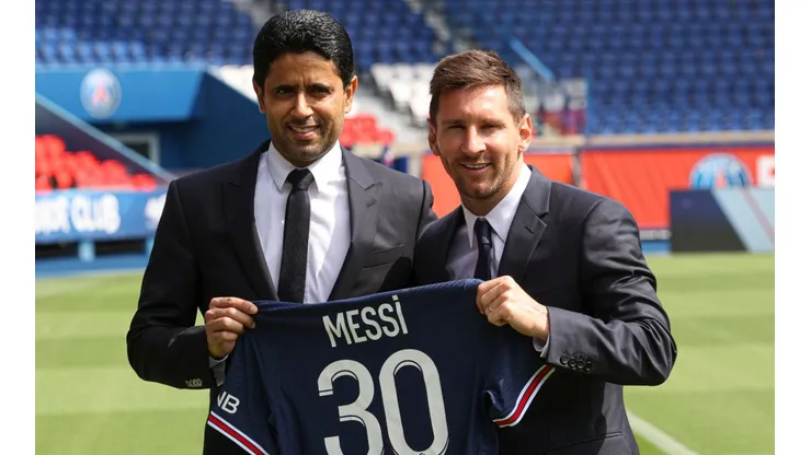 ionel Messi poses with his jersey next to PSG's President Nasser Al Khelaifi (Getty).