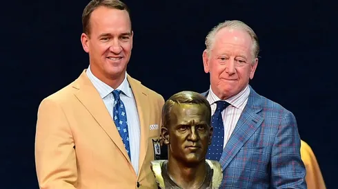 Peyton Manning and his father Archie Manning with Peyton's bust in the NFL Hall of Fame induction ceremonies. (Getty)