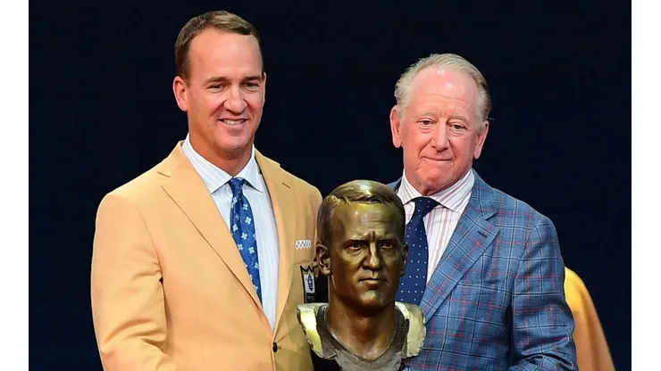 Peyton Manning and his father Archie Manning with Peyton's bust in the NFL Hall of Fame induction ceremonies. (Getty)