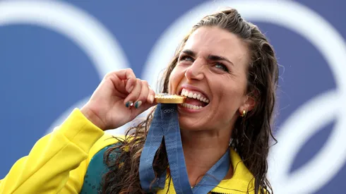 Gold Medalist Jessica Fox of Team Australia bites her medal as she poses on the podium during the Canoe Slalom medal ceremony after the Women’s Kayak Single Final on day two of the Olympic Games Paris 2024 at Vaires-Sur-Marne Nautical Stadium on July 28, 2024 in Paris, France.