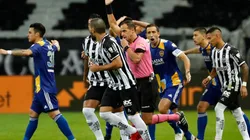 Referee Esteban Ostojich gestures after a VAR review for a possible goal for Boca Juniors as players react during a round of sixteen second leg match between Atletico Mineiro (Getty)
