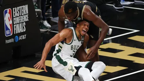 Clint Capela helps an injured Giannis Antetokounmpo. (Getty)