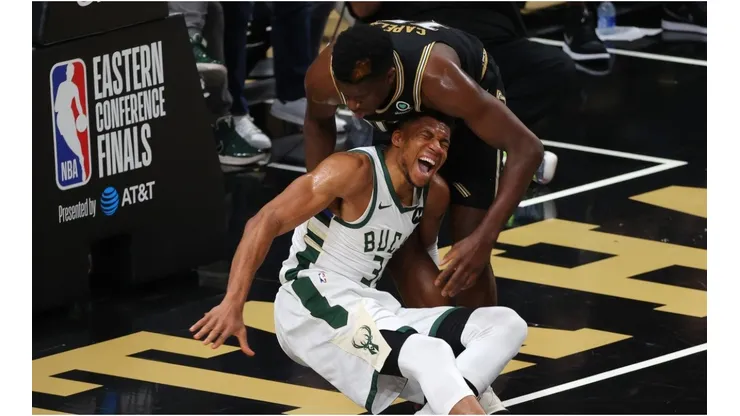 Clint Capela helps an injured Giannis Antetokounmpo. (Getty)