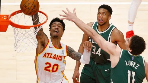 John Collins dunks on Brook Lopez & Giannis Antetokounmpo. (Getty)