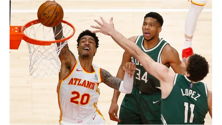 John Collins dunks on Brook Lopez & Giannis Antetokounmpo. (Getty)