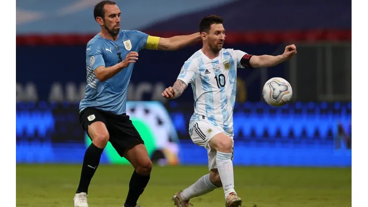 Lionel Messi of Argentina and Diego Godin of Uruguay compete for the ball (Getty).