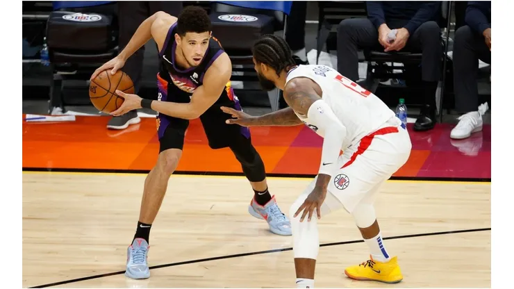 Paul George guarding Devin Booker. (Getty)