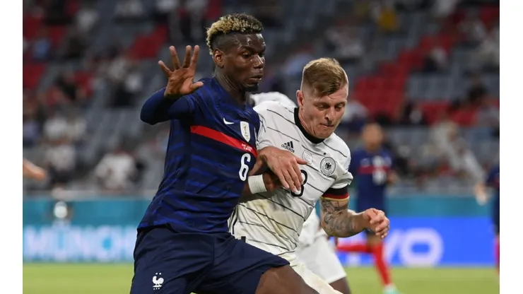 Paul Pogba and Toni Kroos fighting for the ball (Getty).