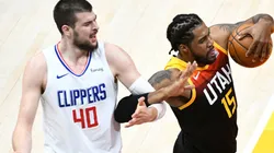 Ivica Zubac of the Los Angeles Clippers (left) fouls Derrick Favors of the Utah Jazz (right). (Getty)