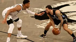 Giannis Antetokounmpo (left) of the Milwaukee Bucks guards Mike James (right) of the Brooklyn Nets. (Getty)