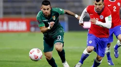Henry Vaca of Bolivia runs for the ball with Gary Medel of Chile (Getty).
