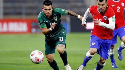 Henry Vaca of Bolivia runs for the ball with Gary Medel of Chile (Getty).