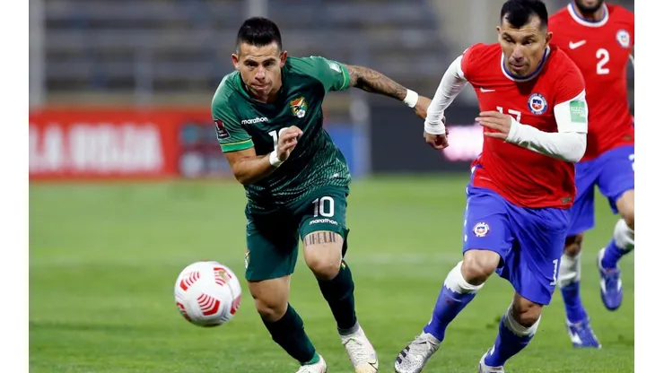 Henry Vaca of Bolivia runs for the ball with Gary Medel of Chile (Getty).