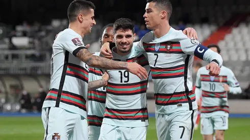 Cristiano Ronaldo (right) of Portugal celebrates with Joao Cancelo (left) and Pedro Neto (center). (Getty)