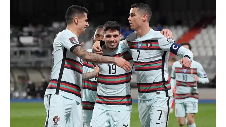 Cristiano Ronaldo (right) of Portugal celebrates with Joao Cancelo (left) and Pedro Neto (center). (Getty)