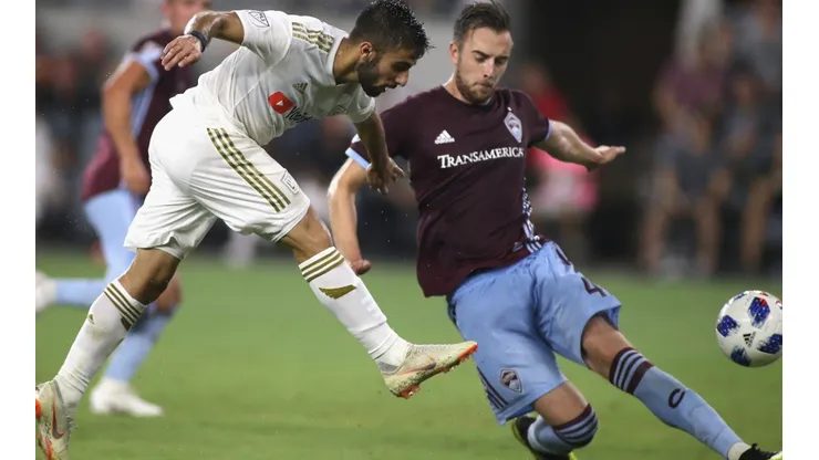 Diego Rossi of Los Angeles FC (left) takes a shot on goal as Danny Wilson of Colorado Rapids attempts to block it (Getty).