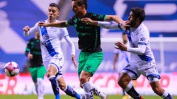 Raúl Rivero (center) of Santos struggles for the ball against Pablo González (right) of Puebla. (Getty)