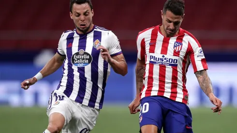 Vitolo of Atletico Madrid (riight) battles for possession with Oscar Plano of Real Valladolid (left). (Getty)
