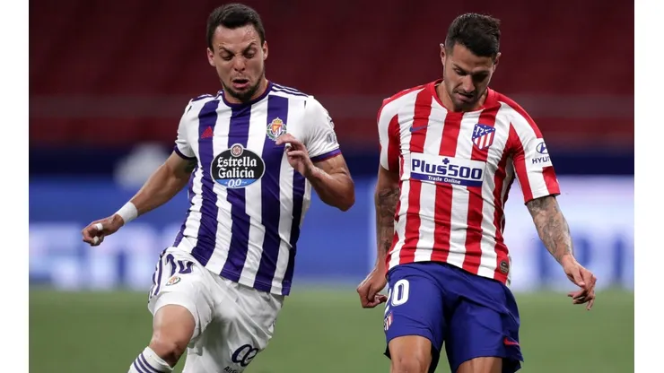 Vitolo of Atletico Madrid (riight) battles for possession with Oscar Plano of Real Valladolid (left). (Getty)
