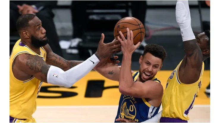 Dennis Schroder & LeBron James guarding Stephen Curry. (Getty)