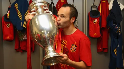 Andres Iniesta of Spain poses in the dressing room with the trophy following the UEFA EURO 2012 final. (Getty)