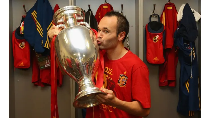 Andres Iniesta of Spain poses in the dressing room with the trophy following the UEFA EURO 2012 final. (Getty)
